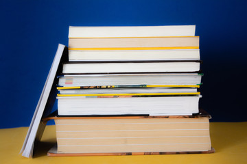 Group of books on a blue background. Concept: reading, literature and education