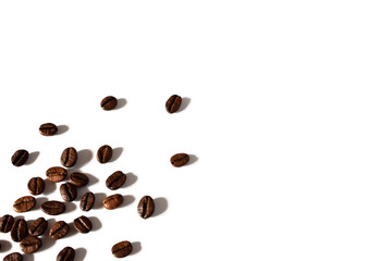 Coffee beans on a white background. Isolate is coffee. Hard shadows. Copy space. Coffee beans with space for text
