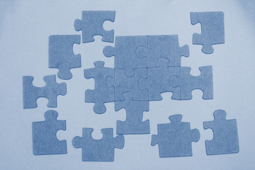 Unfinished puzzle pieces background  toned in trendy color 2020 year classic blue. Top view.