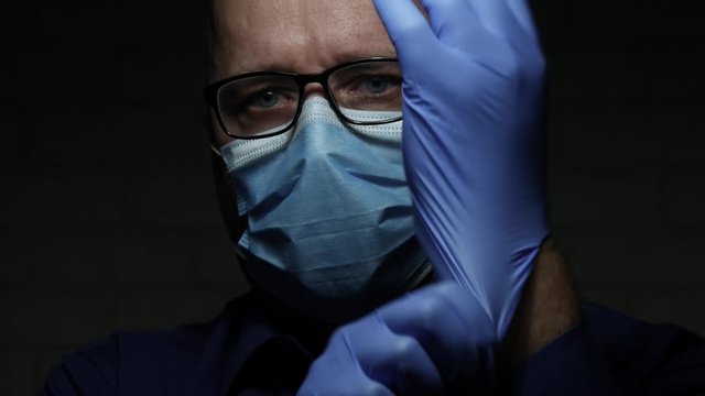 Slow Motion with Doctor Wearing Protective Face Mask and Gloves, Medical Person with Protection Equipment in a Quarantined Hospital Against Virus Epidemic