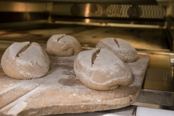 Entering bread loafs in the oven with the shovel