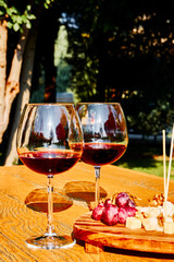 Glasses Of Fine Red Wine With Grape and cheese