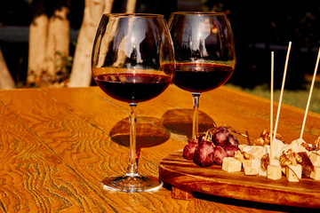 Glasses Of Fine Red Wine With Grape and Cheese