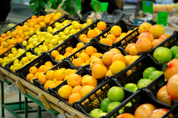 Fresh citrus are on the shelf in the store. a variety of citrus fruits. oranges, tangerines, lime, lemons. supermarket