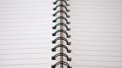 Close up top view of  lines notebook or spiral notepad paper background. Memo notebook paper.