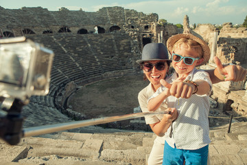 Mother with son take a vacation photo on the Side ampitheatre view. Traveling with kids concept...