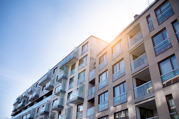 Modern apartment building exterior concept. Sunshine sun flare.