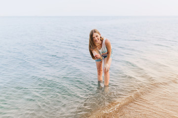 A woman on vacation has fun on the beach, a Woman enjoys splashing water on the beach.