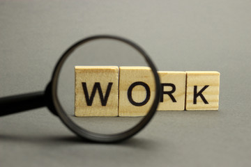 The word Work from wooden letters is a symbol of analysis, verification and research of meaning