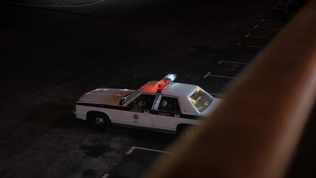 Sheriff's old police car with lights on.