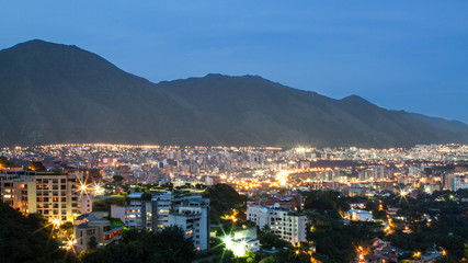 Fototapeta premium Caracas city with The Mount El Avila in the background at dusk