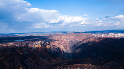 Fototapeta na wymiar Huge iron ore quarry opencast mining of iron ore opencast mining.