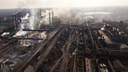 Steel ecology metallurgical iron plant smokes from pollution of industry pipes. View from the drone.