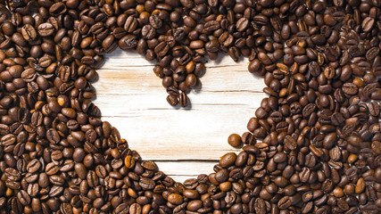 Roasted coffee beans heart shaped frame background image for coffee lovers. place for text