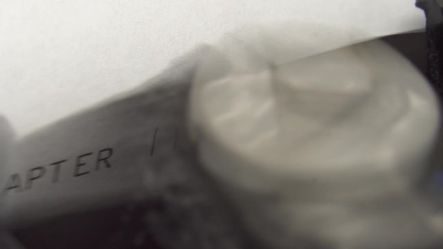 Typing CHAPTER 2 in black ink on an old mechanical typewriter.