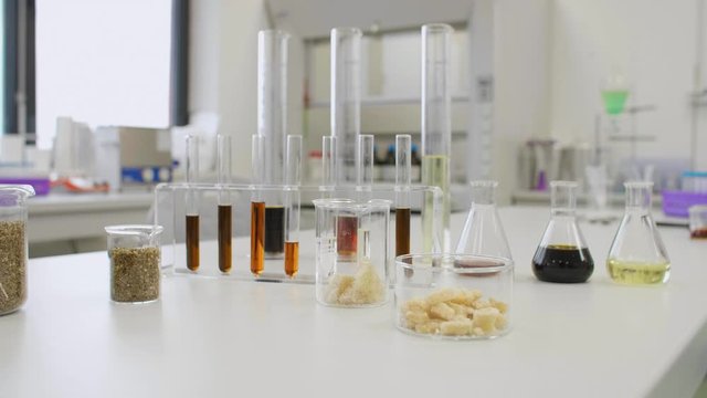 CBD oil, hemp seeds and terpenes in glass on laboratory desk