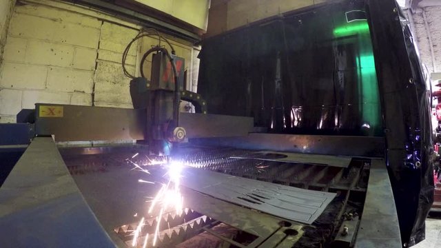 Robot cutting metal with laser beam