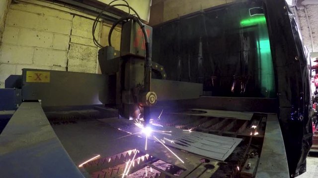 Robot cutting metal with laser beam