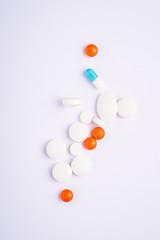 Pills and tablets on bright white background, healthcare medical concept, antibiotics and cure, top view
