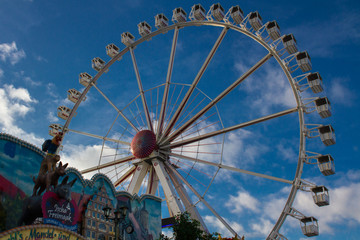 ferris wheel at traditional, historic fun fair in Bremen, Germany on a sunny day with blue sky in...