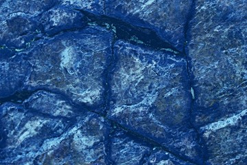 Blue background for graphic design.  Backdrop looks like stones or scales of reptile skin.