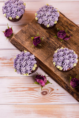 Obraz na płótnie Canvas Chocolate cupcakes on a wooden table with salted caramel inside. Dessert.