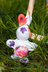 Easter decorative bunny toy on green grass background.