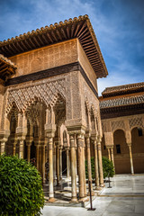 Fototapeta na wymiar An Arabic construction in the Lion's Courtyard in La Alhambra, Granada, Spain with a blue sky