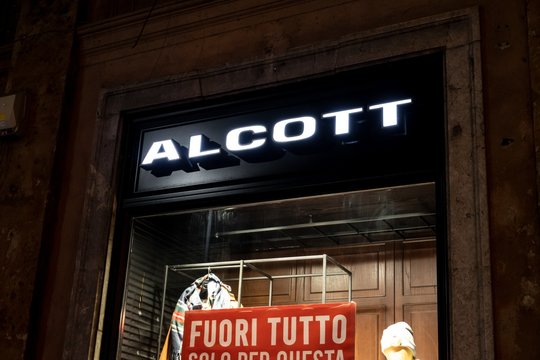 The storefront of the Alcott boutique which sells fashionable clothes. The image was taken at night when the shop is closed.