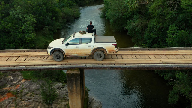 Man Sitting Photographing On Top Of Pickup Truck, Serra Da Canastra National Park