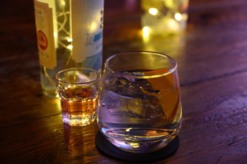Glass of gin with tonic water, orange and ice