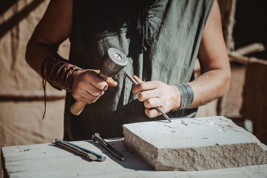 catching craftsman working in craft trade during the medieval days held in the city of Avila, Spain, during the month of September 2019..