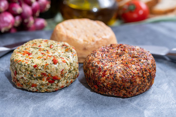 Different french soft goat cheeses made with spices and herbs