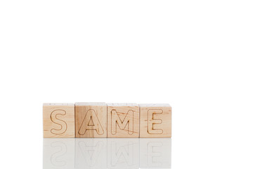 Wooden cubes with letters same on a white background