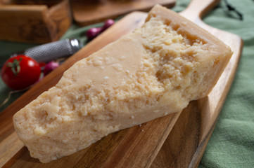 One piece of authentic Parmigiano-Reggiano or Parmesan Italian hard, granular cheese