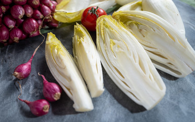Fresh Belgian endive or chicory bitter salad ready to cook or eat