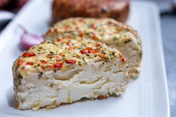 Different french soft goat cheeses made with spices and herbs