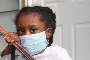 Kid wearing surgical mask outside