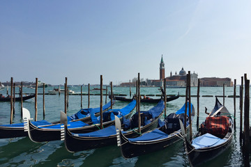 Venetian boats gondolas in harbor in Venice, Italy.