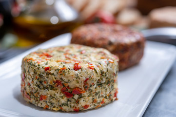 Different french soft goat cheeses made with spices and herbs