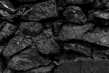 Black mystical wall of large stones