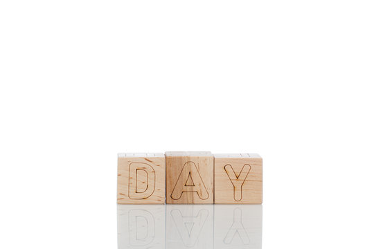 Wooden cubes with letters day on a white background