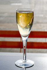 Glass of champagne on a table in an airport business lounge isolated against a burred backgoround