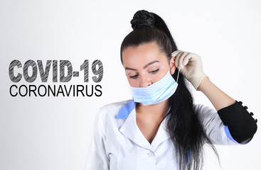 Covid-19 coronavirus desease global pandemic outbreak. A young female doctor putting on medical mask.