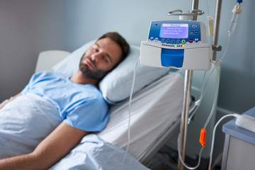 Man being treated with an infusion pump in a hospital
