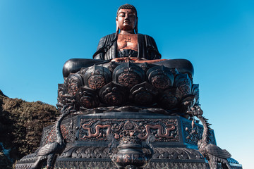 Fansipan mountain in Sapa, Vietnam. Statue of the Guan-Yin Buddha and Pavilion on Fansipan mountain peak the highest mountain in Indochina Backdrop Beautiful view blue sky in early morning.