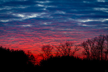 Fototapeta premium Spring sunset sky with clouds in red and blue