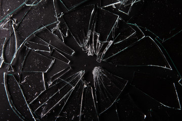 Close up of broken glass on dark background with lots of glass splinters