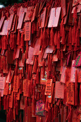 Red praying wish cards hang on traditional stand written in Chinese Pray Fortune, in Huayan Si temple
