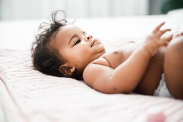 Obraz na płótnie Canvas Adorable newborn child lying on pink blanket